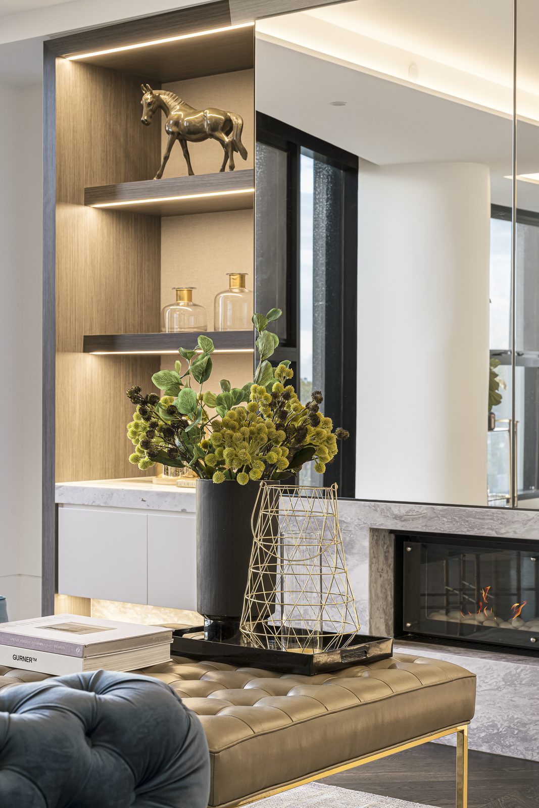 Styled interior vignette with brass and florals
